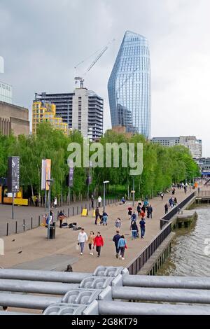 Vertical view of One Blackfriars tower and people walking along the River Thames path after covid restrictions eased in South London UK   KATHY DEWITT Stock Photo