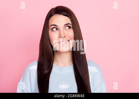 Photo of sweet cute young woman wear blue pullover biting lip looking empty space isolated pink color background. Stock Photo