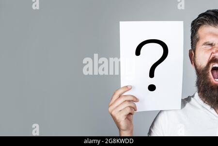 Screaming man. Getting answers, scream. Question mark, symbol. Concept - challenging issue, looking for the answer. Man screaming, emotion. Man Stock Photo