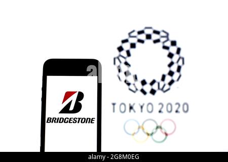 Barcelona, Catalonia, Spain. 20th July, 2021. In this photo illustration a Bridgestone logo seen displayed on a smartphone with a Tokyo 2020 Olympic Games logo in the background. (Credit Image: © Thiago Prudencio/DAX via ZUMA Press Wire) Stock Photo