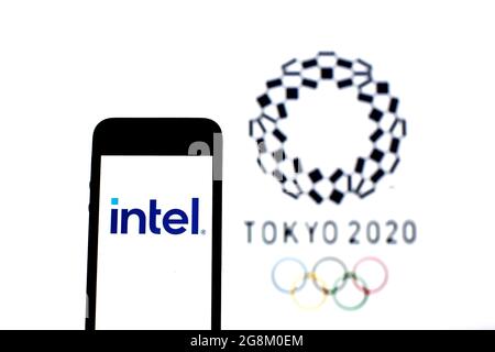 Barcelona, Catalonia, Spain. 20th July, 2021. In this photo illustration a Intel Corporation logo seen displayed on a smartphone with a Tokyo 2020 Olympic Games logo in the background. (Credit Image: © Thiago Prudencio/DAX via ZUMA Press Wire) Stock Photo