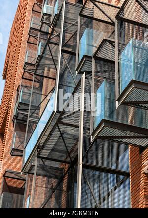 Architectural detail. Metal-grille cantilevered balconies and brick facade for the Red Apple residential building in Sofia, Bulgaria Stock Photo