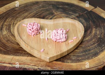 Closeup of two red fruit brigadiers on a wooden stump board. Stock Photo