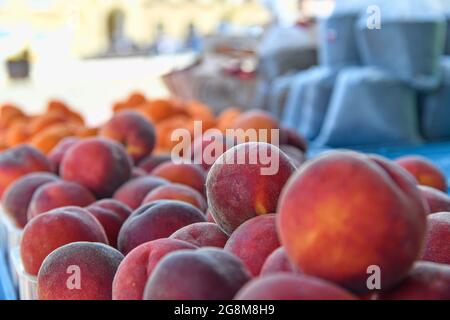 Peaches and apricots and other fruit and vegetables for sale at local farmers market. Fresh organic produce for sale at local farmers market Stock Photo