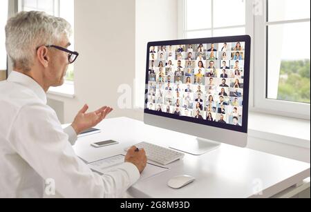 Man having an online meeting with diverse business people from all over the world Stock Photo