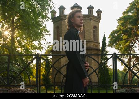 Christian priest with cross standing by the church. Stock Photo