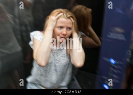 Woman With Claustrophobia In Elevator. Claustrophobia in small space concept Stock Photo