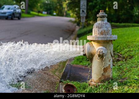 Water Flowing from open Fire Hydrant Stock Photo