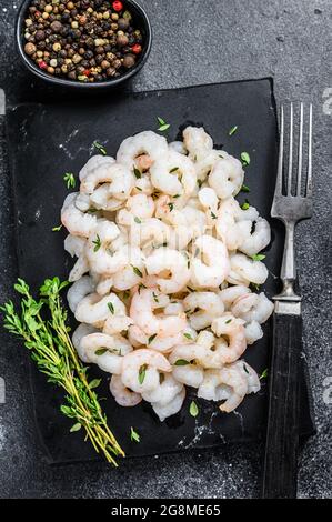 Peeled Shrimps, Prawns on a marble board. Black background. top view Stock Photo