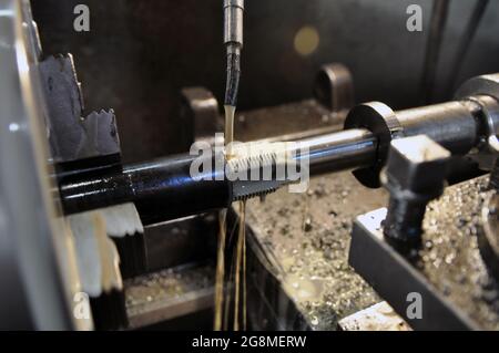 Cutting a thread in a workpiece. Cooling lubricant supply. Stock Photo