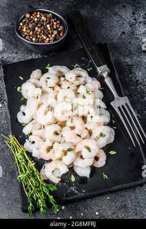 Peeled Shrimps, Prawns on a marble board. Black background. top view Stock Photo