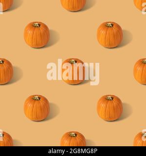 Pumpkin seamless pattern on a beige background. Vegetable pattern for the print. Autumn abstract food background. Stock Photo
