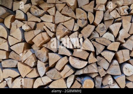Neatly folded, chopped firewood. Harvesting firewood for the winter, preparing for the heating season. Stock Photo