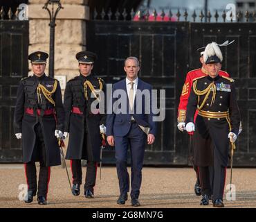 Horse Guards Parade, London, UK. 21 July 2021. Dominic Raab MP, Foreign Secretary, arrives at Horse Guards Parade as VIP Guest and Salute Taker at the start of the evening military musical spectacular The Sword & The Crown on the historic parade ground accompanied by Major General C J Ghika CBE (right), to watch the first public appearance of the massed bands of the Household Division since June 2019. Credit: Malcolm Park/Alamy Live News. Stock Photo