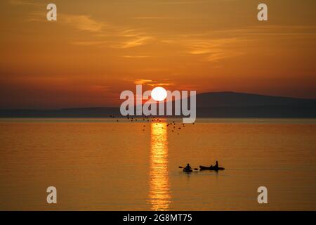 Morecambe, Lancashire, United Kingdom. 21st July, 2021. Two Kyakers on Morcambe Bay off Sandylands Promenade Credit: PN News/Alamy Live News Stock Photo