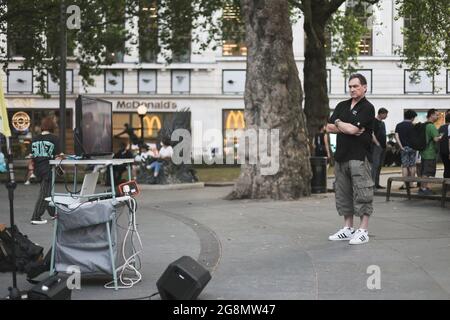 London, UK. 21st July, 2021. A passerby stop to watch the documentary. Hongkongers in London gathered on the 2nd year anniversary of the 721 Yuen Long Mob Attack to screen the documentary of the events. (Photo by Hesther Ng/SOPA Images/Sipa USA) Credit: Sipa USA/Ģ����ý Live News Stock Photo