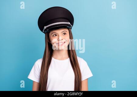 Portrait of attractive cheerful girl wearing hat dreaming copy empty blank space isolated over bright blue color background Stock Photo