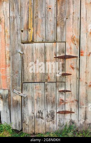 Latah, Washington, USA. Door with rusted hinges on a weathered old barn. Stock Photo