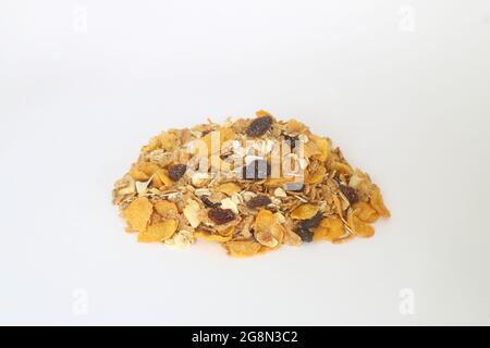 Healthy muesli with oat flakes, nuts and raisins isolated on white background. Stock Photo