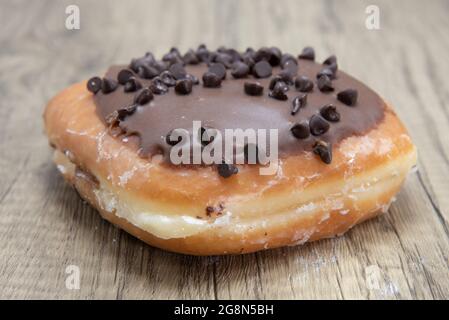 Chocolate chip bar donut is textured with sprinkled chip coating for a sweet treat delight. Stock Photo