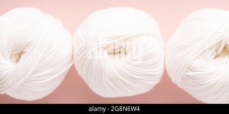 White clews of wool on a pink background. Top view. Close-up - Image Stock Photo