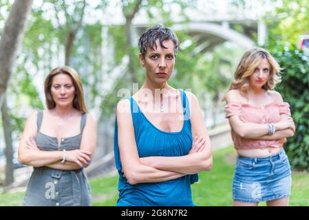Three serious middle aged women looking at camera with their arms crossed Stock Photo
