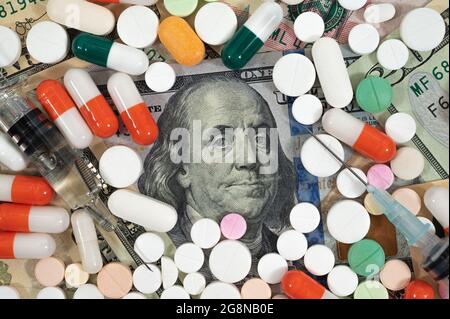 U.S. $100 bills and various types of medicines. Stock Photo