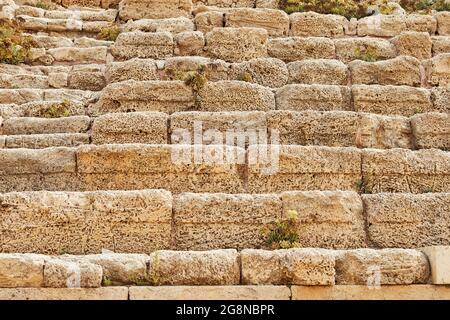 Background of the stone wall of the castle made of stones of different shapes and sizes and textures Stock Photo