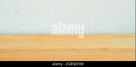 Background. A wooden table and a gray wall with black dots. Copy space Stock Photo