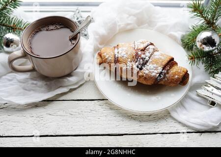 Hot Coffee cup on a frosty winter day window background