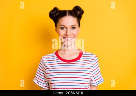 Photo of adorable sweet young lady wear striped t-shirt smiling isolated yellow color background Stock Photo