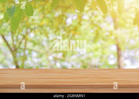 Empty wood table top over blur green nature background for product display or montage. Stock Photo