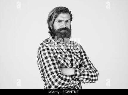 brutal bearded man wear checkered shirt having lush beard and moustache, barbershop Stock Photo