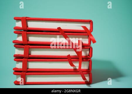 Red notebook on a green table. Stock Photo