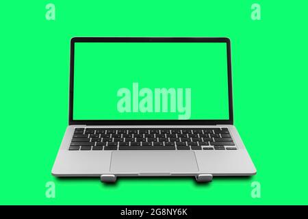 Laptop with blank green screen isolated on green background. Stock Photo