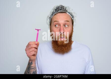 wondered man adjust the beard with a razor blade Stock Photo