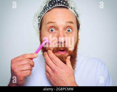 Man adjust the beard with a razor blade Stock Photo