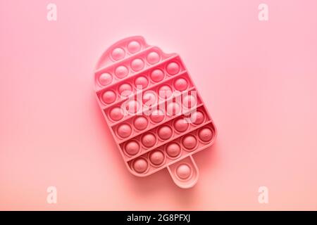 Color antistress Pop it fidget toy on yellow background with copy space Stock Photo
