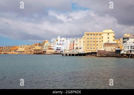 Panoramic views of the small coastal town and tranquil holiday resort with seafront hotels and buildings, coffee shops, bars and restaurants, Tenerife Stock Photo