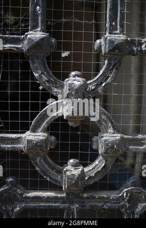 iron bar gate with wire mesh behind Stock Photo