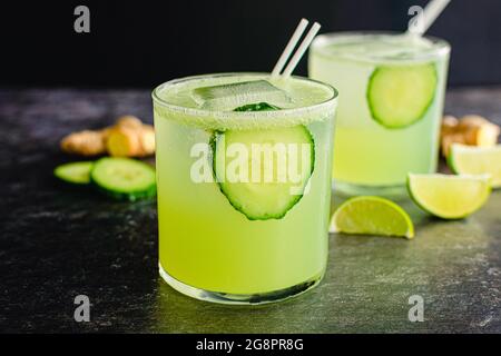 Tart and Crisp Cucumber Ginger Gin Fizz Cocktails: Gin fizz cocktails made with cucumber, ginger, and lime juice Stock Photo
