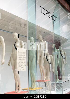 A Goodbye message from staff to customers pinned on the glass next to the clothesless mannequins in the window of the closed Topshop and Topman store Stock Photo