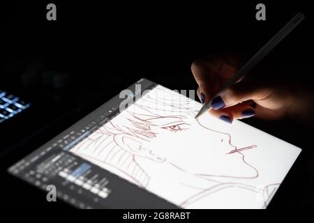 SANTA MARIA CAPUA VETERE, ITALY - Jul 21, 2021: Digital artists hand using graphics tablet. Majority of image is out of focus. Caserta, Italy, July 07 Stock Photo