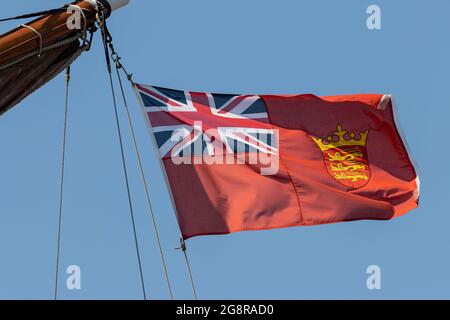 Jersey civil ensign hoisted up on the stern of a sailing ship Stock Photo