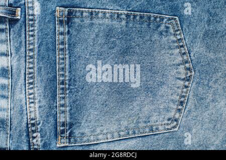 Close up on a back pocket of a blue jeans. Fabric and stitching details of the back pocket of a pair of jeans. Stock Photo