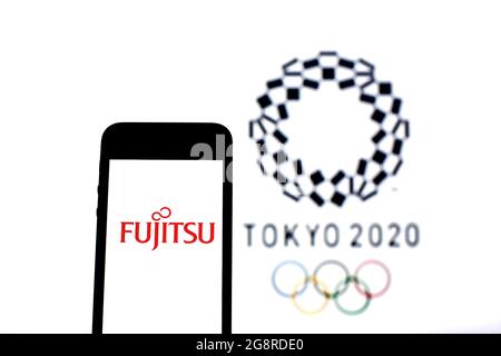 Spain. 20th July, 2021. In this photo illustration a Fujitsu Ltd. logo seen displayed on a smartphone with the Tokyo 2020 Olympic Games logo in the background. Credit: SOPA Images Limited/Alamy Live News Stock Photo