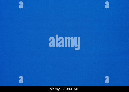 Texture of vibrant light blue flat fabric made of polyester material. Fabric background in light blue tone. Stock Photo