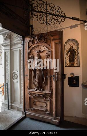 Religious art on the wooden door of St. Leodegar church in Lucerne, Switzerland Stock Photo