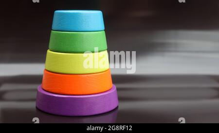 multicolor child's pyramid on black background Stock Photo