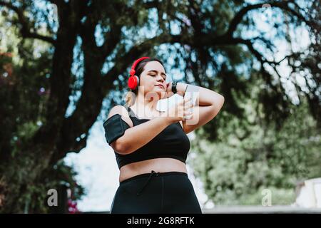 plus size young latin woman running in park in Mexico